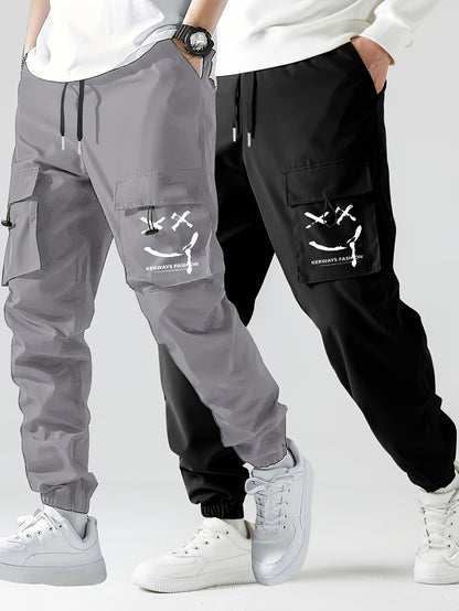 2 piezas de jogging tipo cargo con diseño de cara sonriente y elegante para hombres con bolsillos, ropa inferior informal con cordón transpirable para hombres para caminar por la ciudad, colgar en la calle y actividades al aire libre